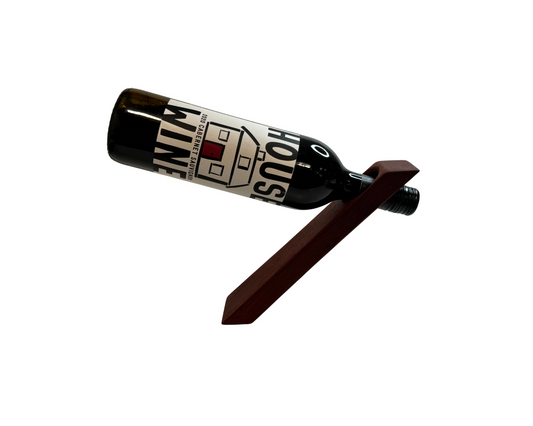 TinyShop Woodworks small gravity wine bottle wooden holder displaying a red wine bottle suspended at an angle